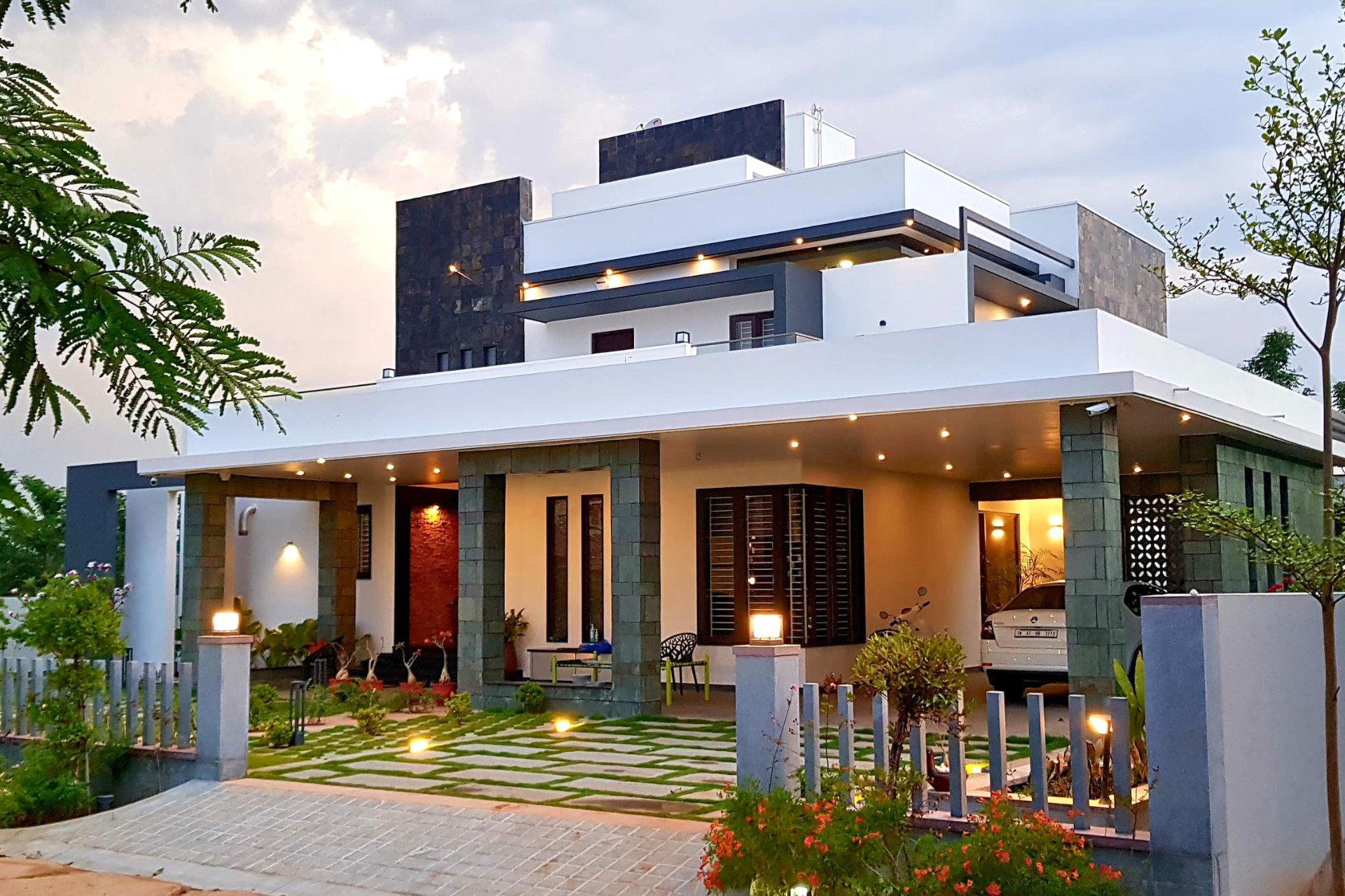 Modern luxury villa designed by Design Plus Architects in Namakkal, featuring contemporary architecture, landscaped gardens, and elegant exterior lighting
